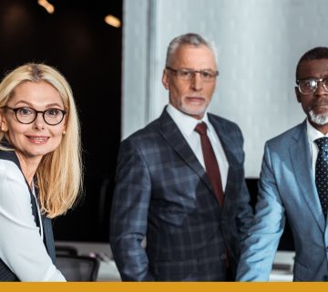 An_image_of_three_leaders_standing_by_a_table
