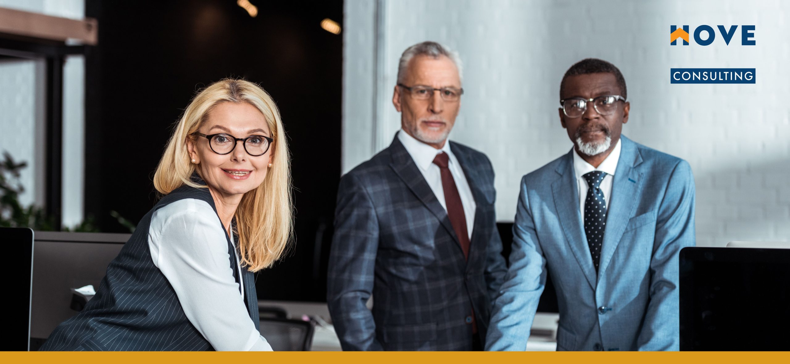 An_image_of_three_leaders_standing_by_a_table